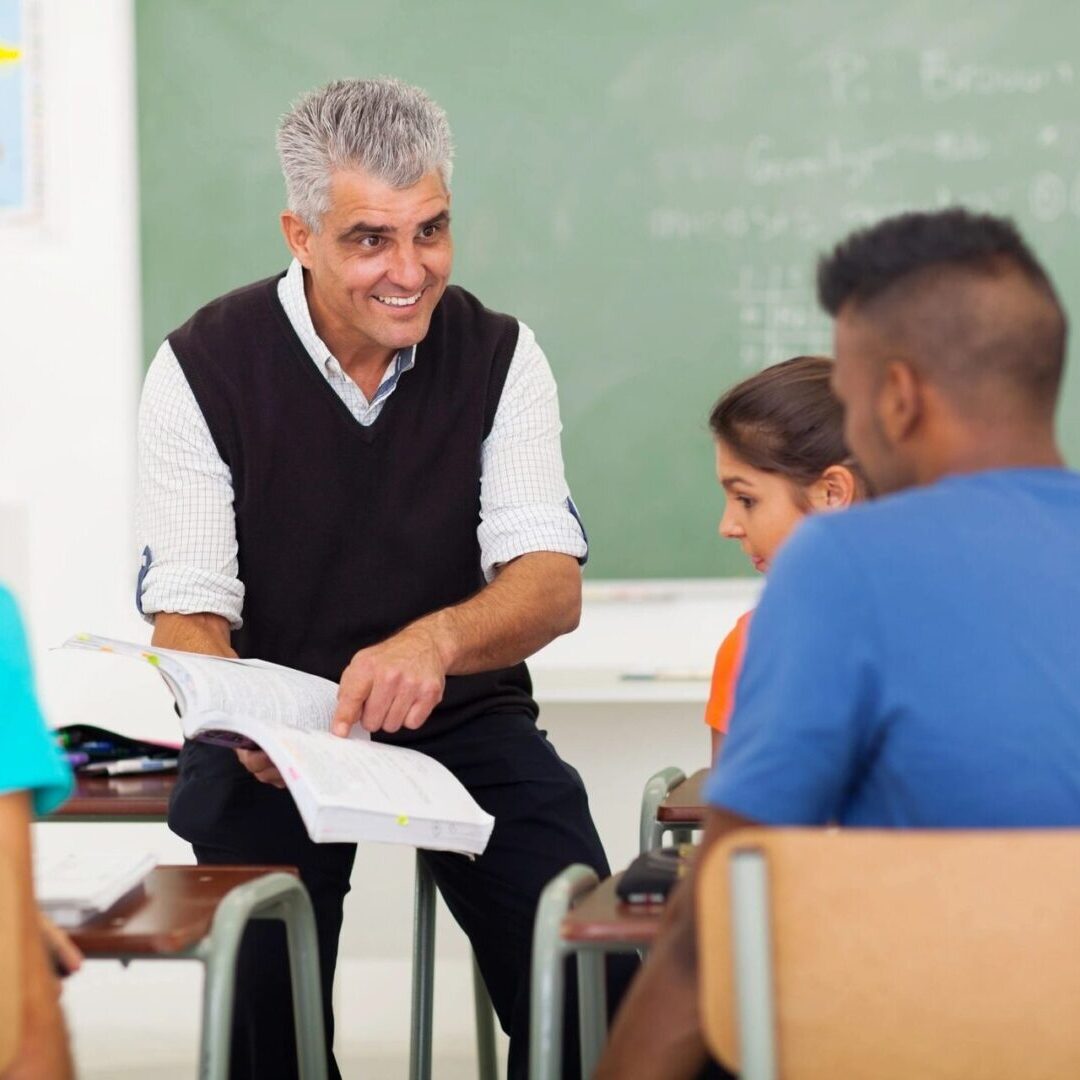 A man sitting in front of several people.